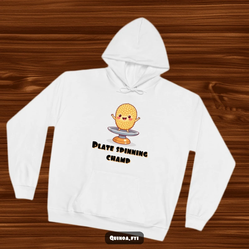 Funny Quinoa Hoodie: A happy quinoa grain character performing a balancing act on a small, spinning plate, offering warmth and humor.