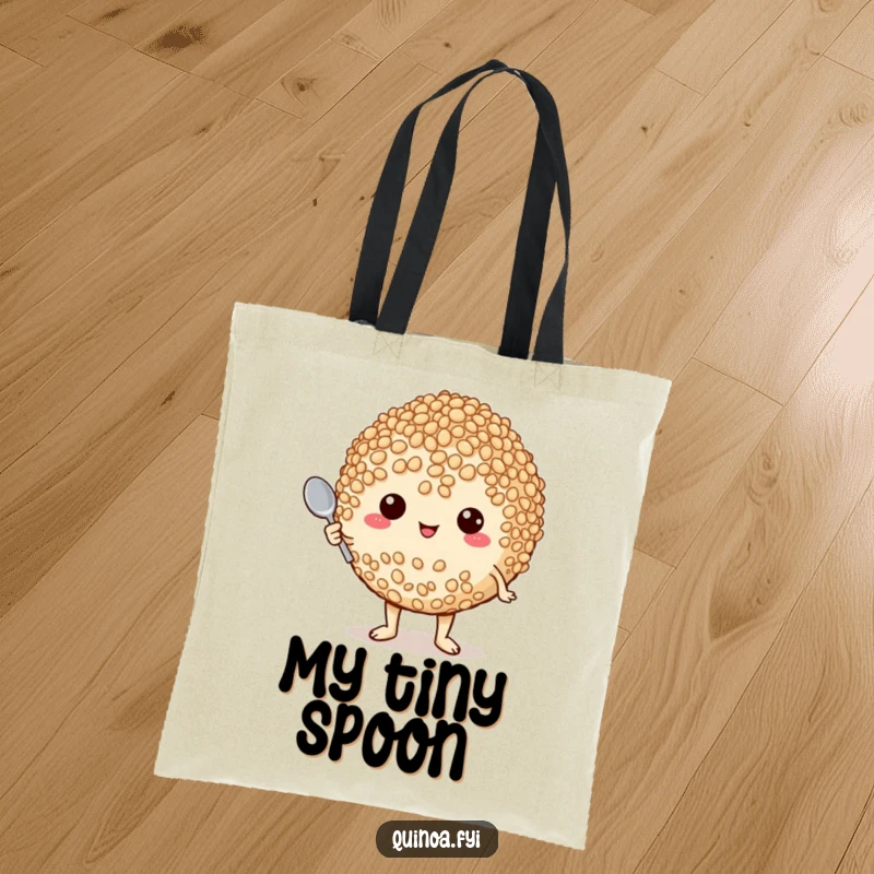 Funny tote bag displaying a plump, proud quinoa character holding a tiny spoon, symbolizing culinary passion and humor.